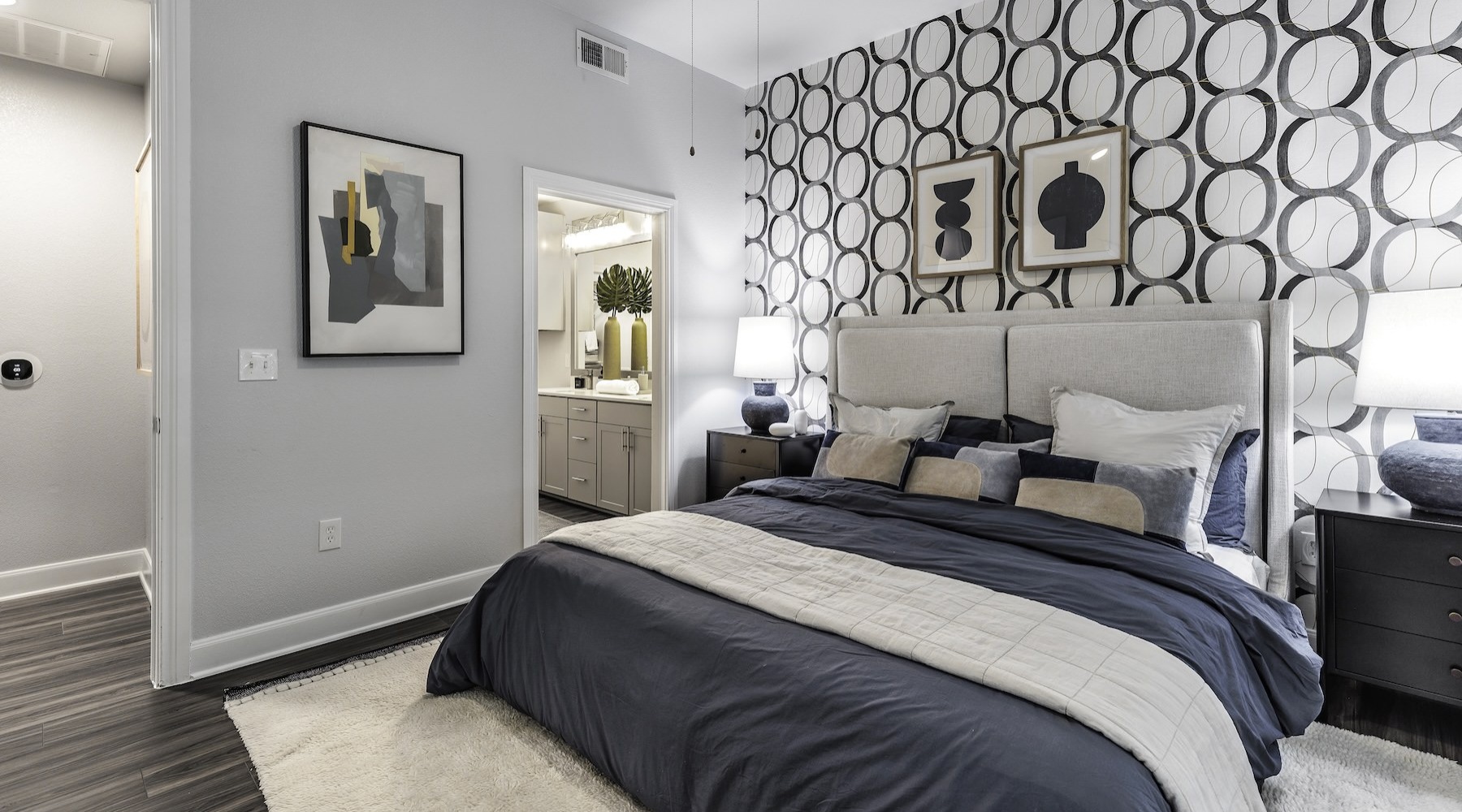 a bedroom with a bed and a mirror