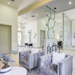 a lounge with chairs and a table